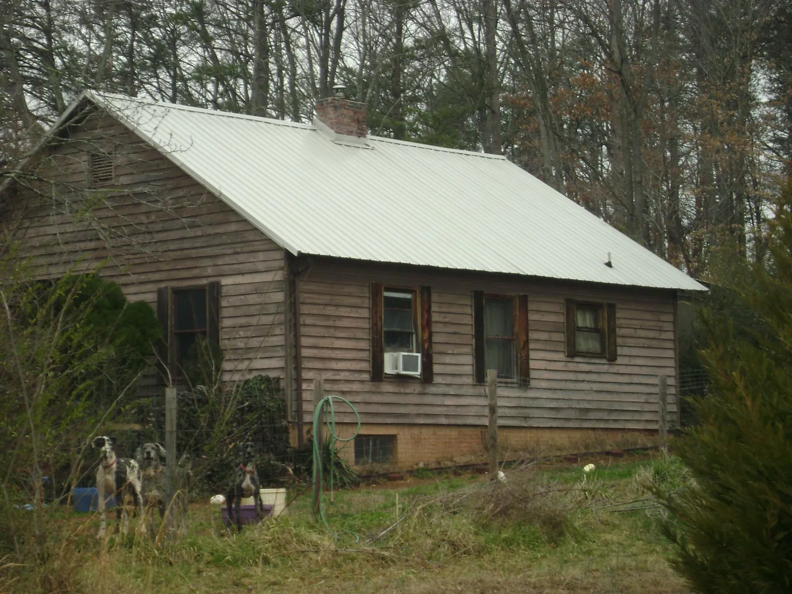 White metal roof on an old wood sided farmhouse, from a Metal Roof Installation job in Sharon
